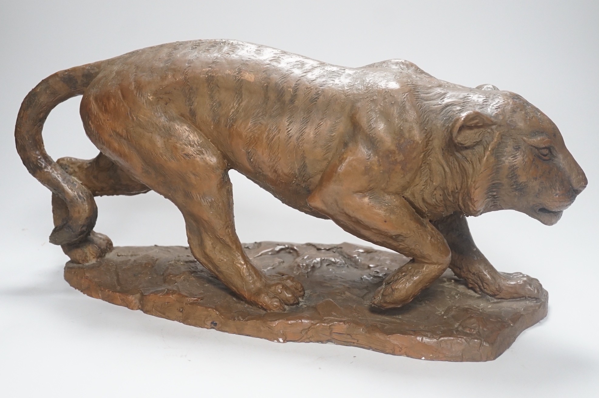 A cold cast resin bronze model of a prowling tiger, 45cm long